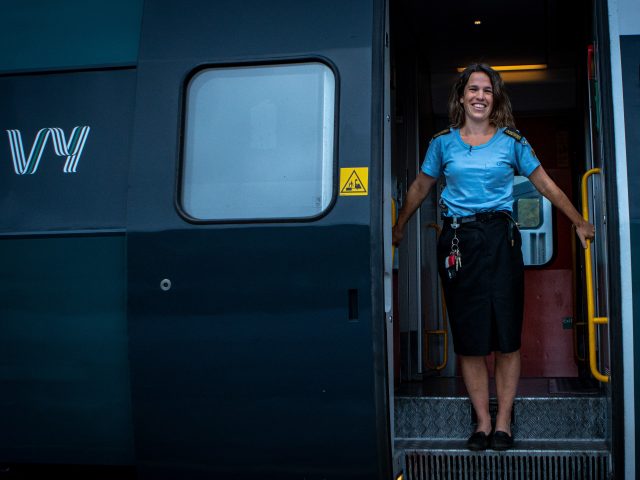 A traindriver standing in the door of the train-Maverix - Visit Norway2